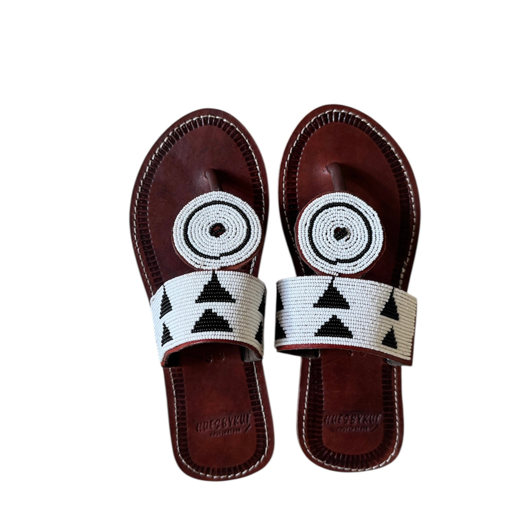 
Nabo beaded leather sandals with black and white Maasai beadwork on white background