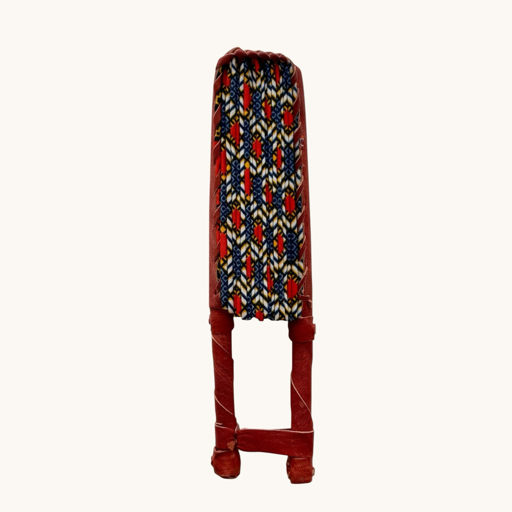 Hues by Kui handcrafted folding fan with vibrant geometric Ankara print fabric and a red genuine leather handle.