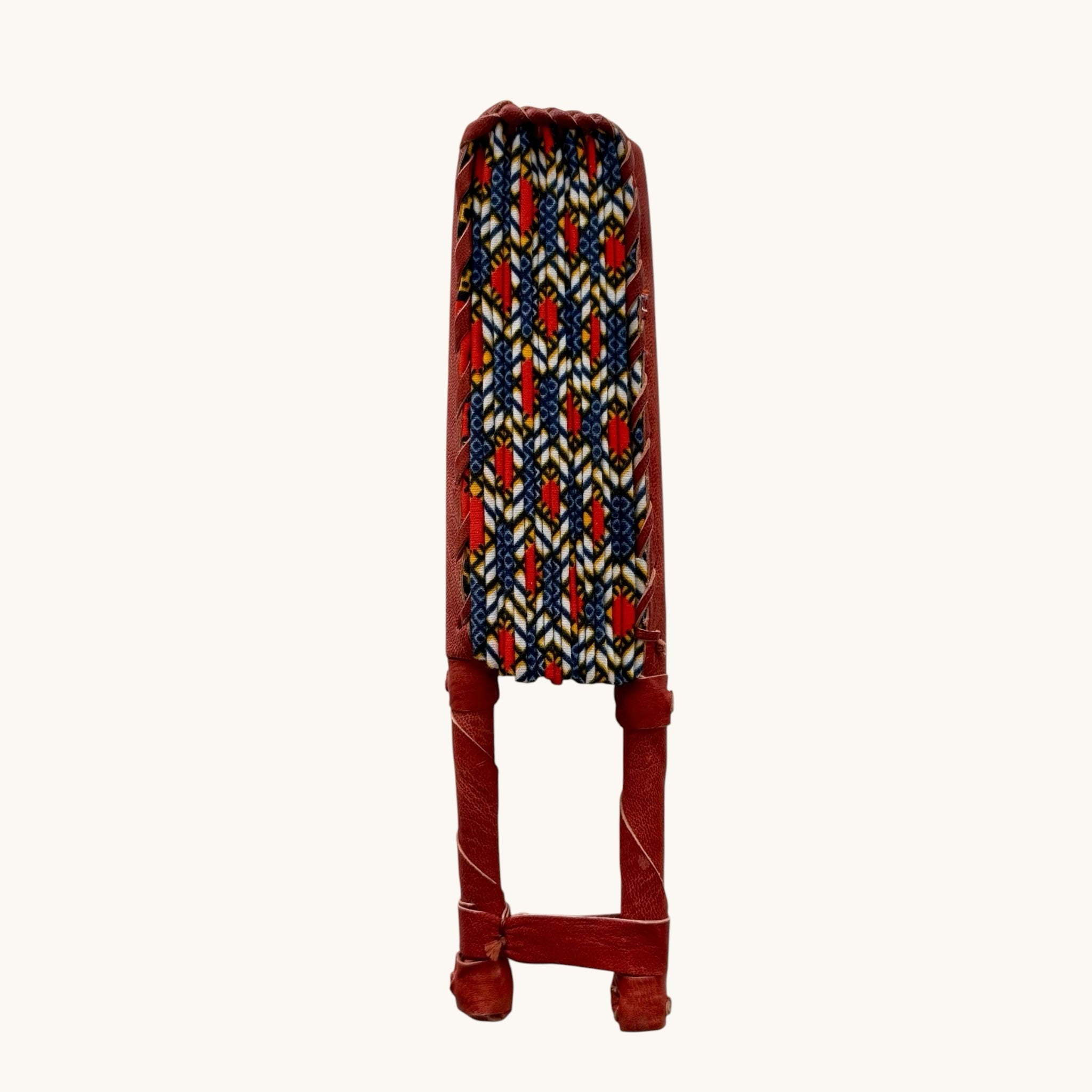 Hues by Kui handcrafted folding fan with vibrant geometric Ankara print fabric and a red genuine leather handle.