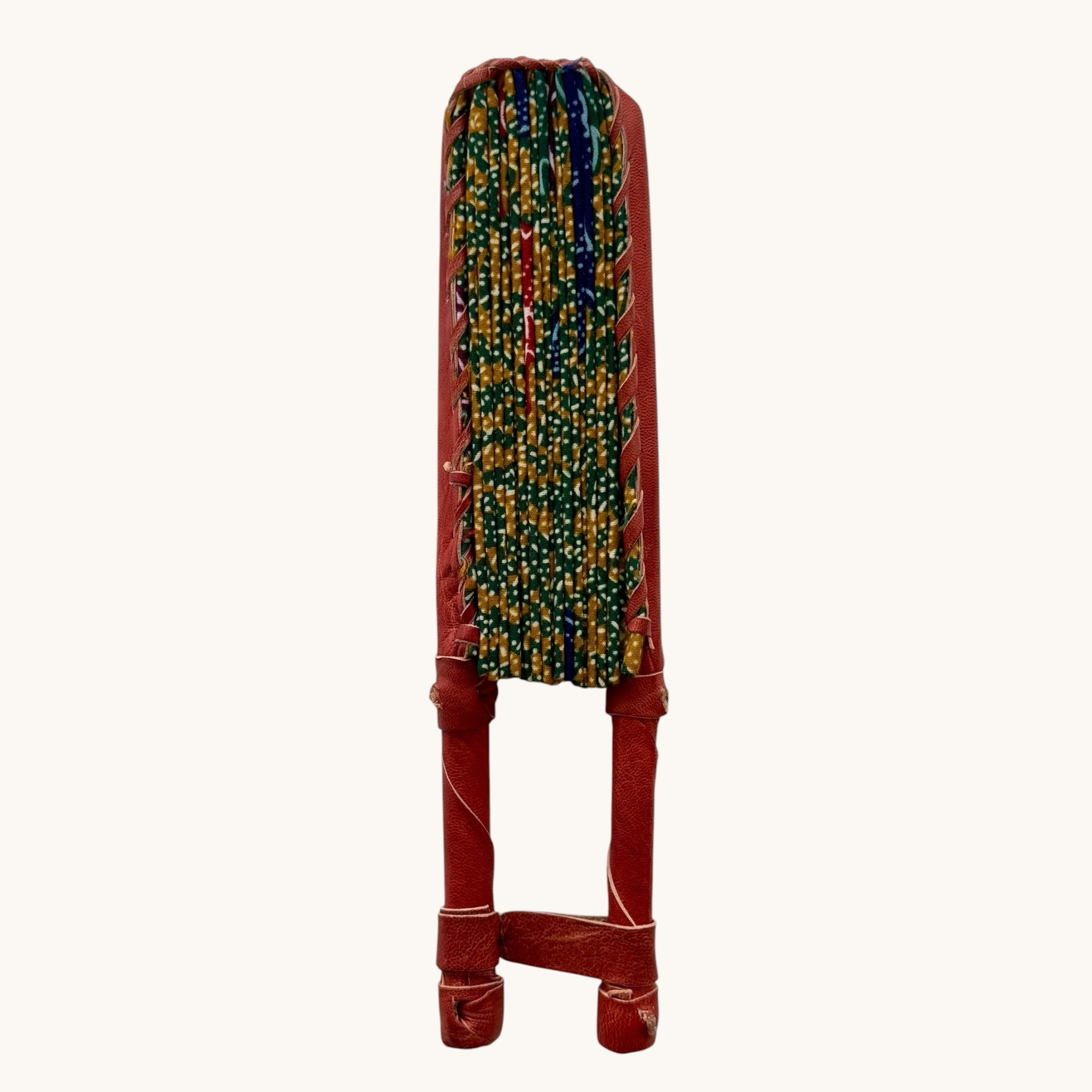 Hues by Kui traditional folding fan with batik-inspired yellow, green, and blue fabric and red leather handles.