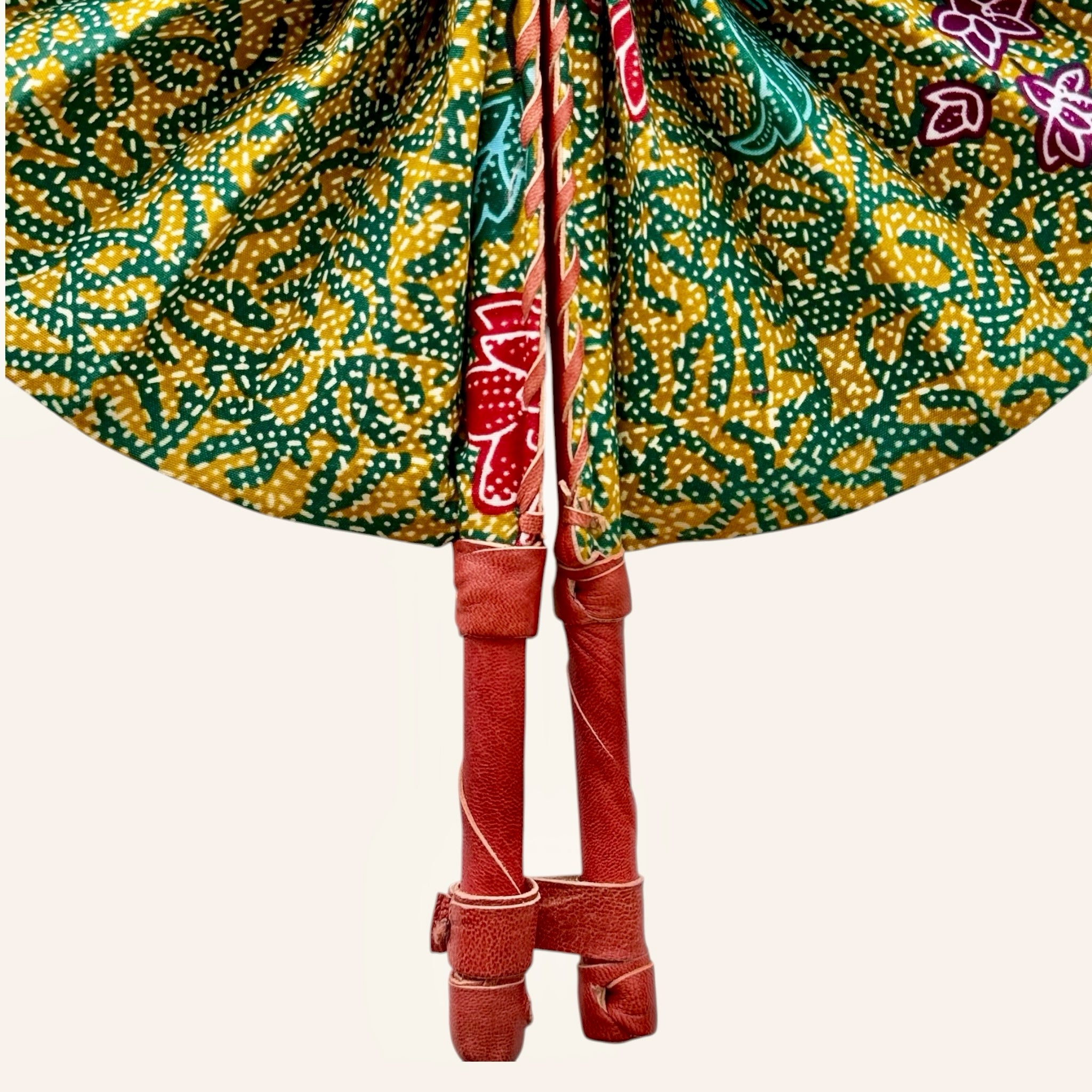 Hues by Kui traditional folding fan with yellow, green, and blue batik fabric and brown leather handles.