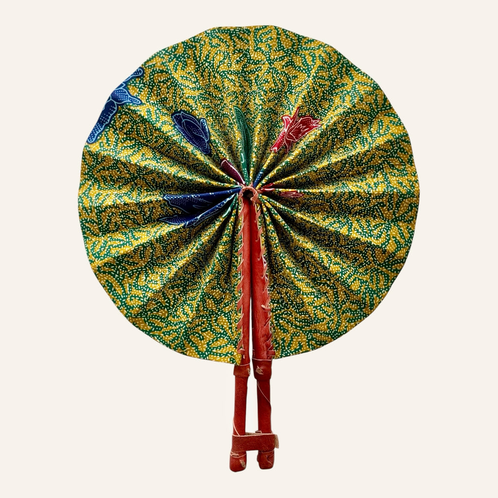 Hues by Kui traditional folding fan with yellow, green, and blue batik fabric and durable leather handles.