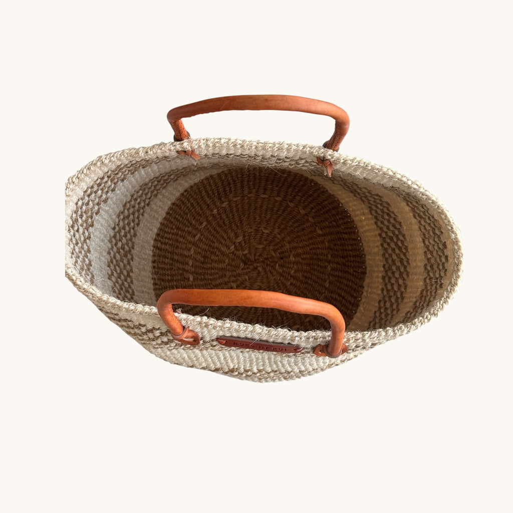 Hues by Kui handwoven tote bag with natural fibre stripes and tan leather handles, top-down view.