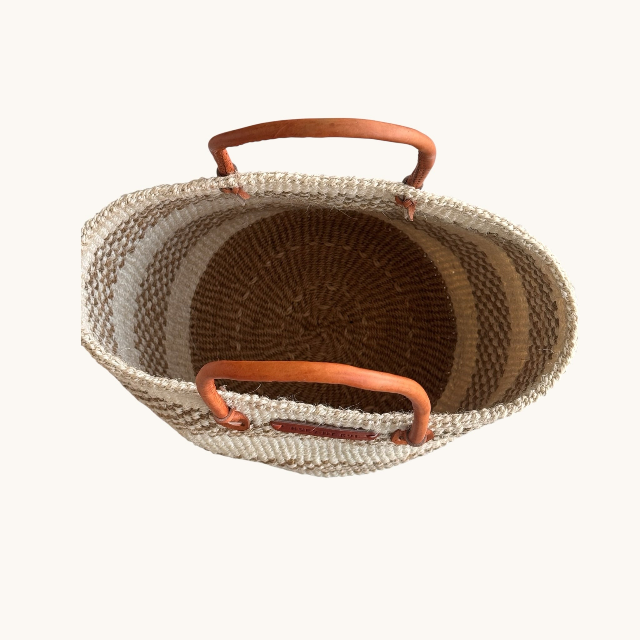 Hues by Kui handwoven tote bag with natural fibre stripes and tan leather handles, top-down view.