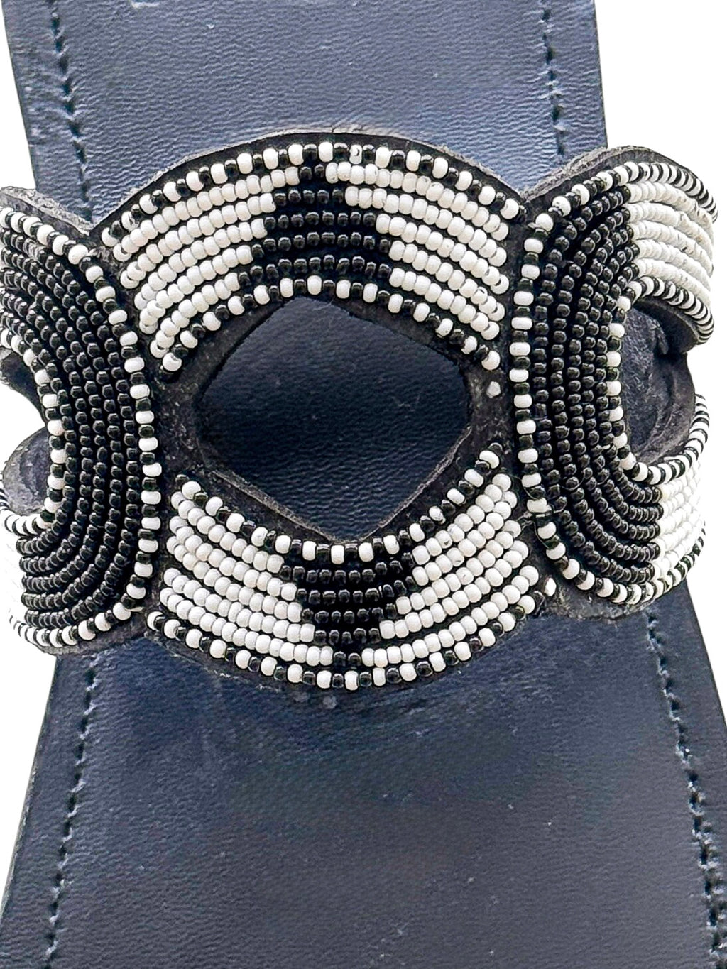 Close up of black and white curved beadwork on Nala leather sandal