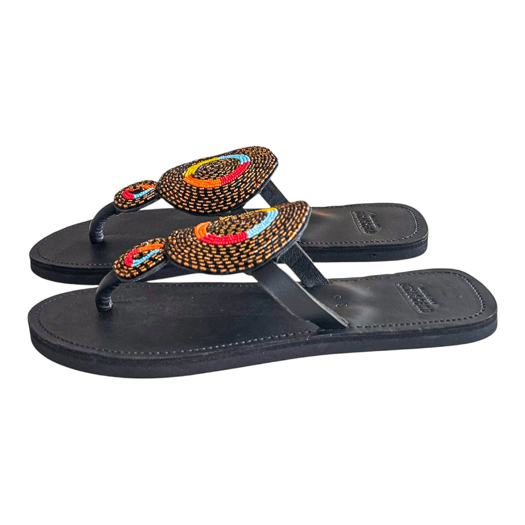
Side view of Nuru handcrafted leather sandals with raised circular bead detail
