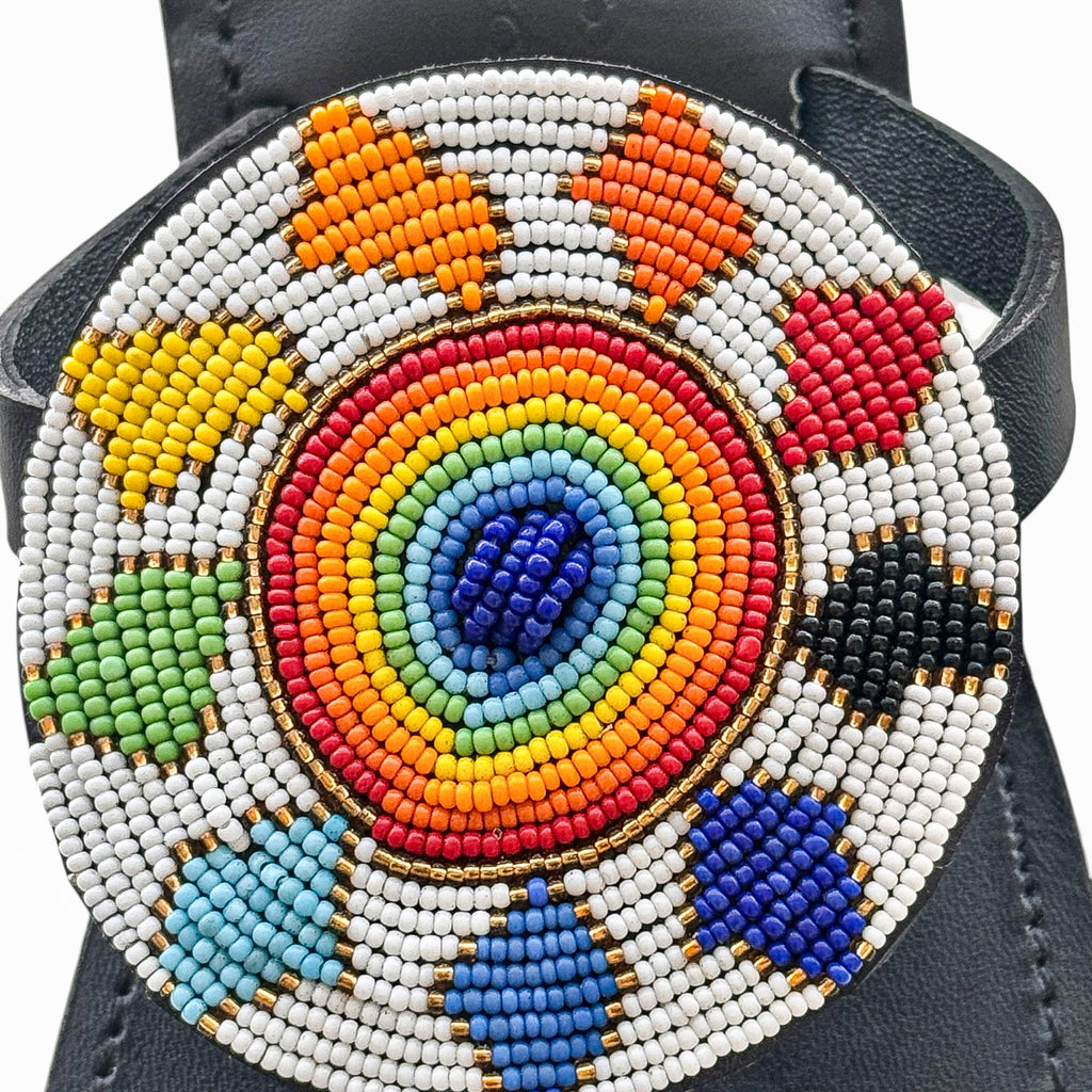 Close up of circular rainbow beadwork on Samawati black leather sandal
