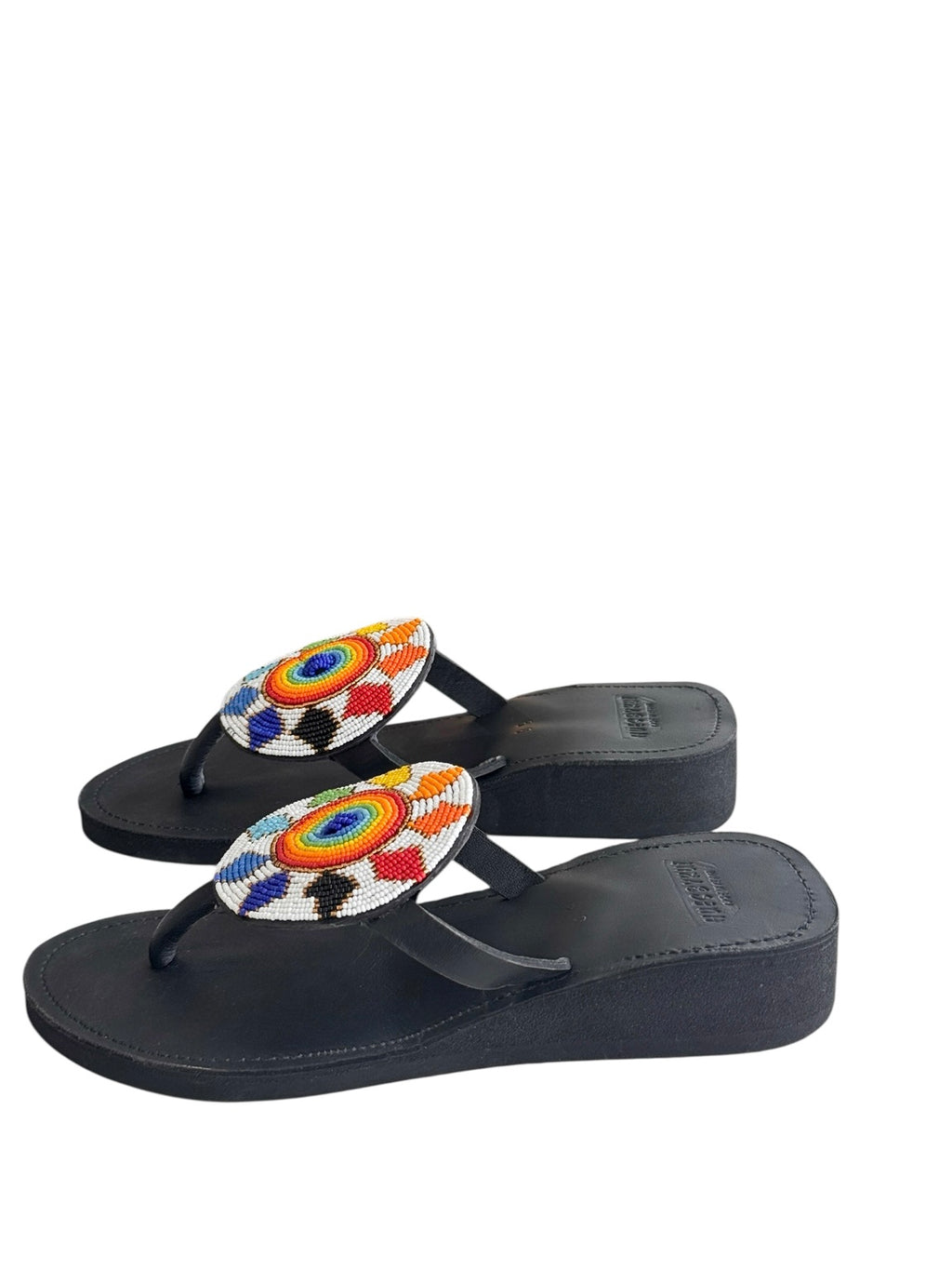 Side view of Samawati handmade leather sandals with raised sole and beaded detail
