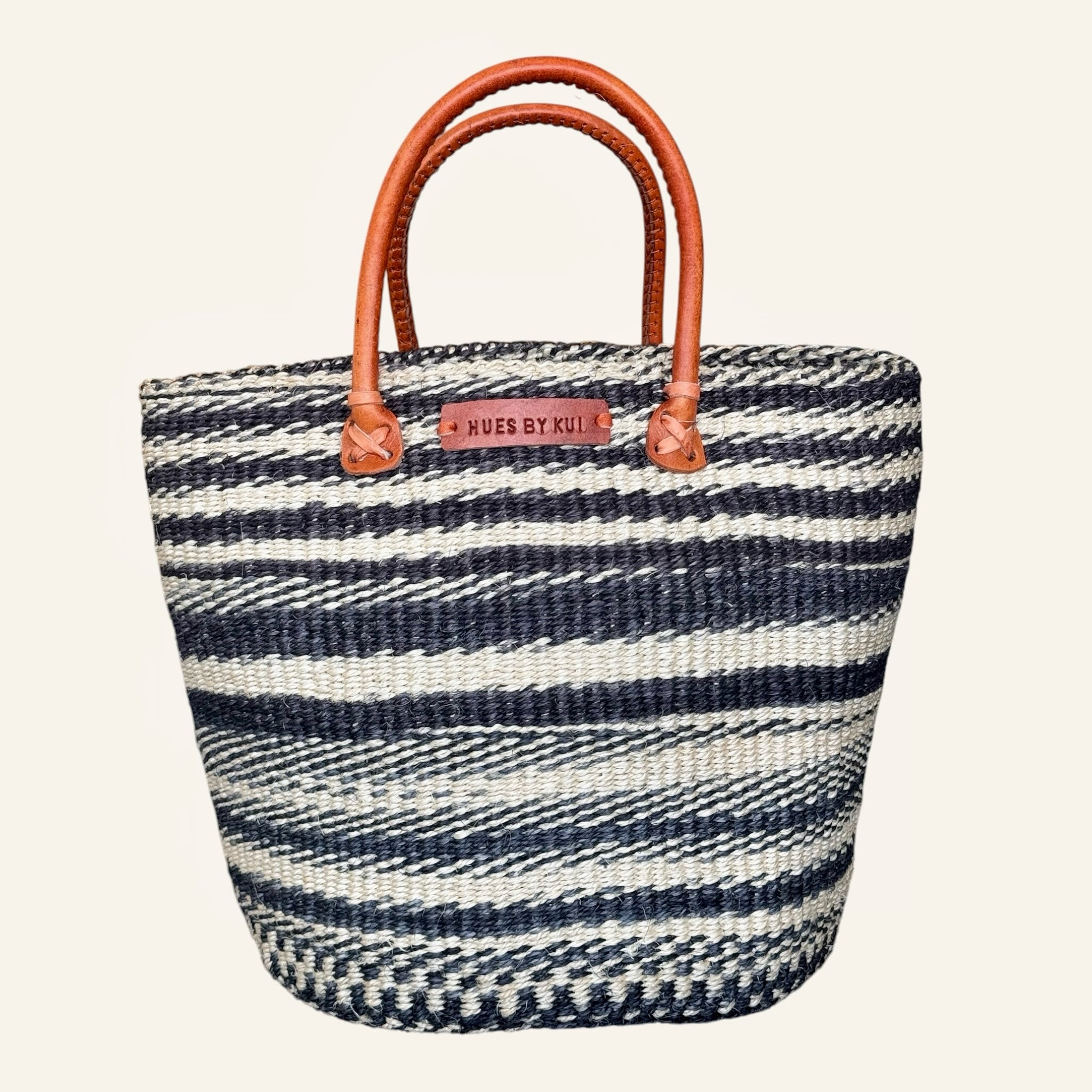 Hues by Kui handwoven straw tote bag with monochrome stripes and tan leather handles