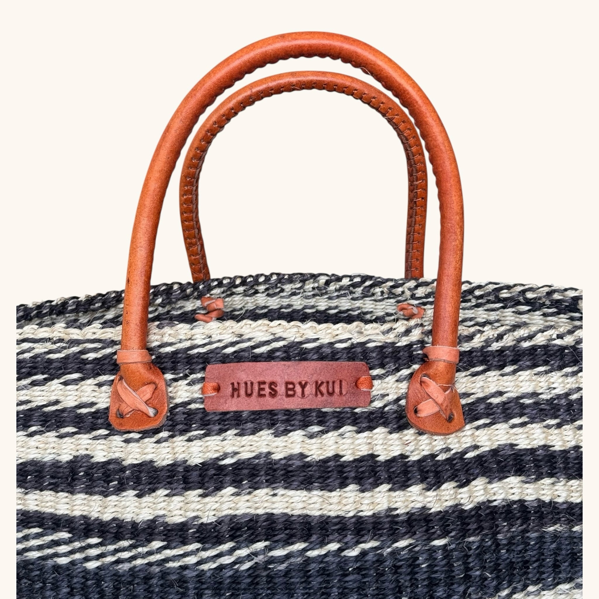 Hues by Kui handwoven straw tote bag with monochrome striped pattern and tan leather handles
