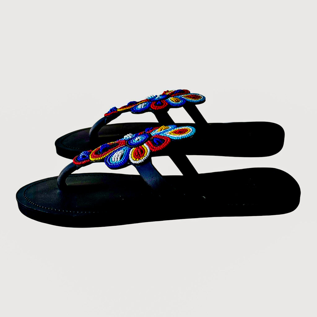 Side view of Tausi handcrafted leather sandals with raised floral bead detail
