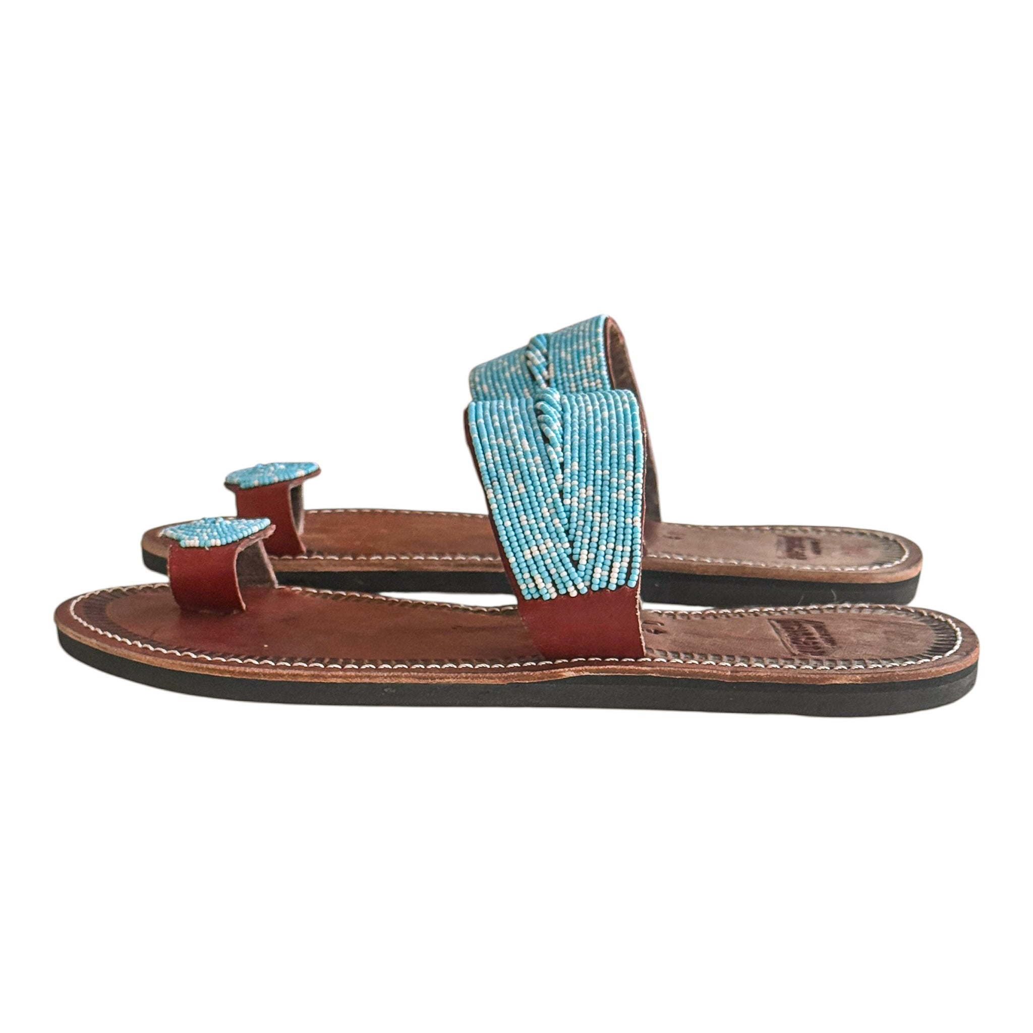 Side view of Tulia handmade leather sandals with turquoise beaded upper and stitched sole

