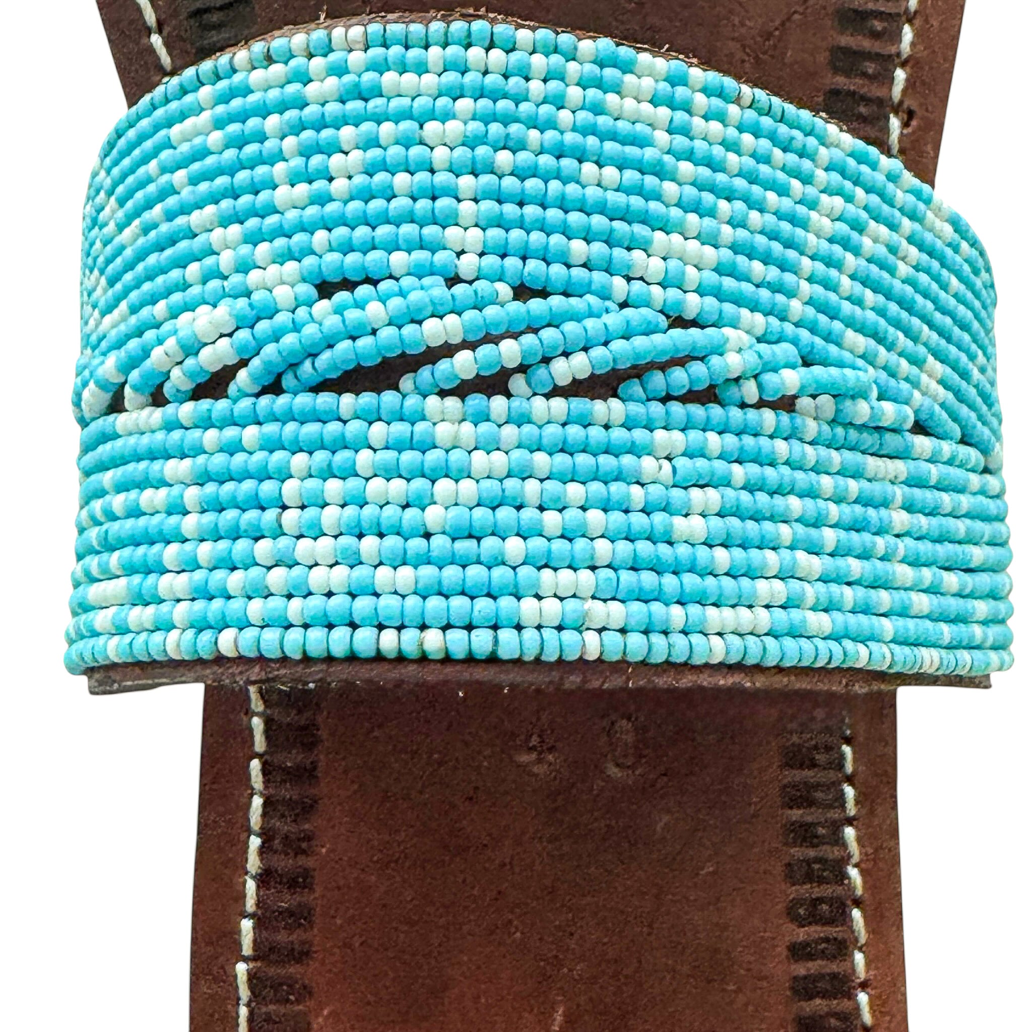 Detail of circular turquoise bead design on Tulia handmade leather sandal
