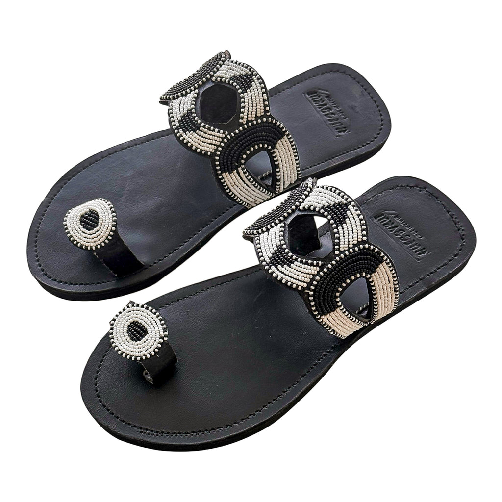 
Black leather beaded sandals featuring curved monochrome detail – Nala by Hues by Kui